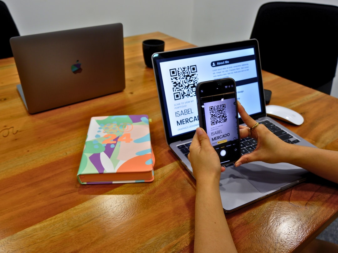 A person scanning a QR code on an applicants resume to view their online portfolio.
