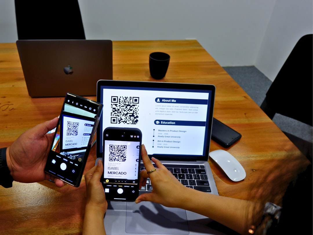 People scanning a QR code on an applicants resume to view an online portfolio.